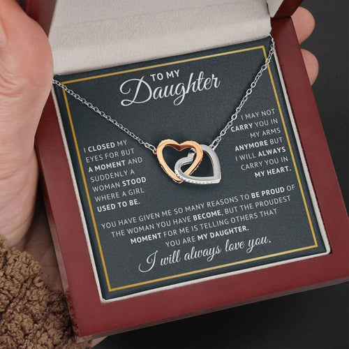 The Always Connected Hearts necklace with 'To My Daughter' message card in a luxury wood gift box, held in hand