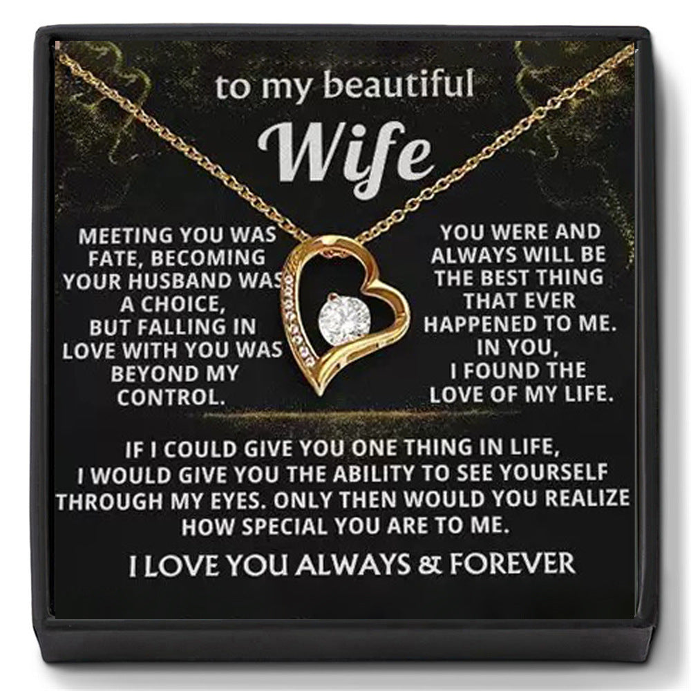 Close-up of the 'To My Beautiful Wife' message card with gold open heart necklace