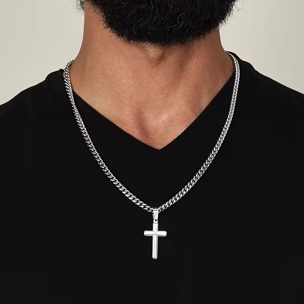 Man wearing the silver cross necklace on a Cuban link chain